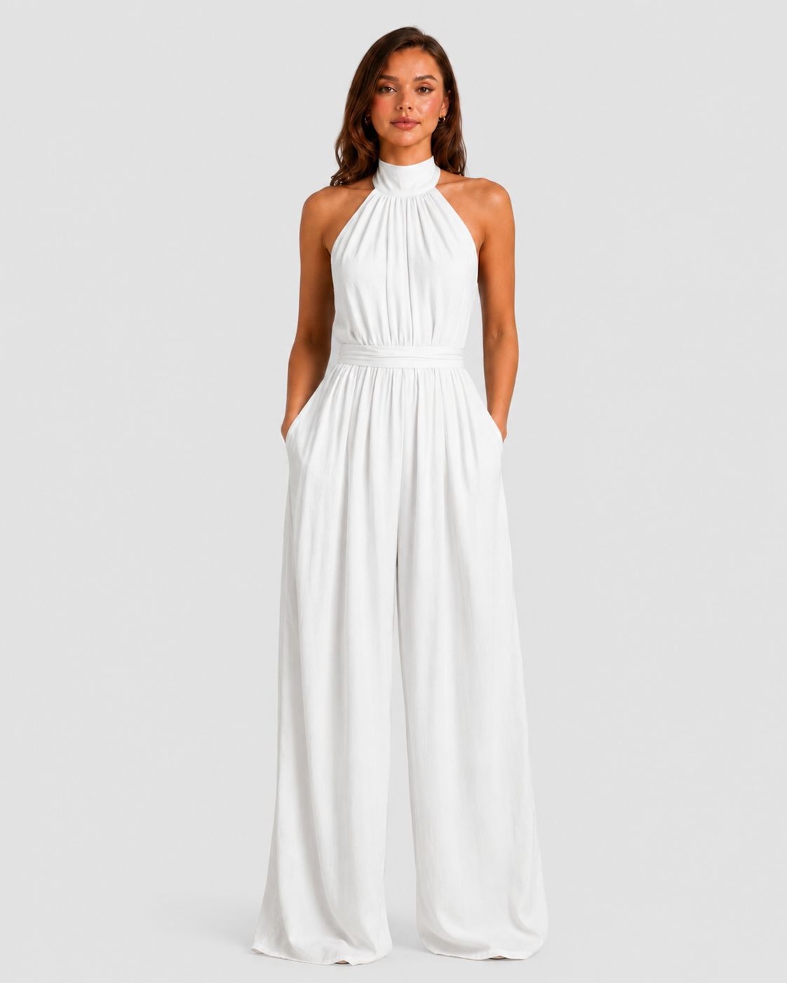 Woman wearing a halter neck wide leg jumpsuit with a defined waistband, flowing silhouette, sleeveless design, and elegant draped fabric for formal occasions.