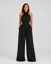 Woman wearing a halter neck wide leg jumpsuit with a defined waistband, flowing silhouette, sleeveless design, and elegant draped fabric for formal occasions.
