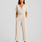 Woman wearing a lightweight wrap front co-ord set with relaxed cropped wide-leg trousers, styled for elegant summer occasions and holiday wear.