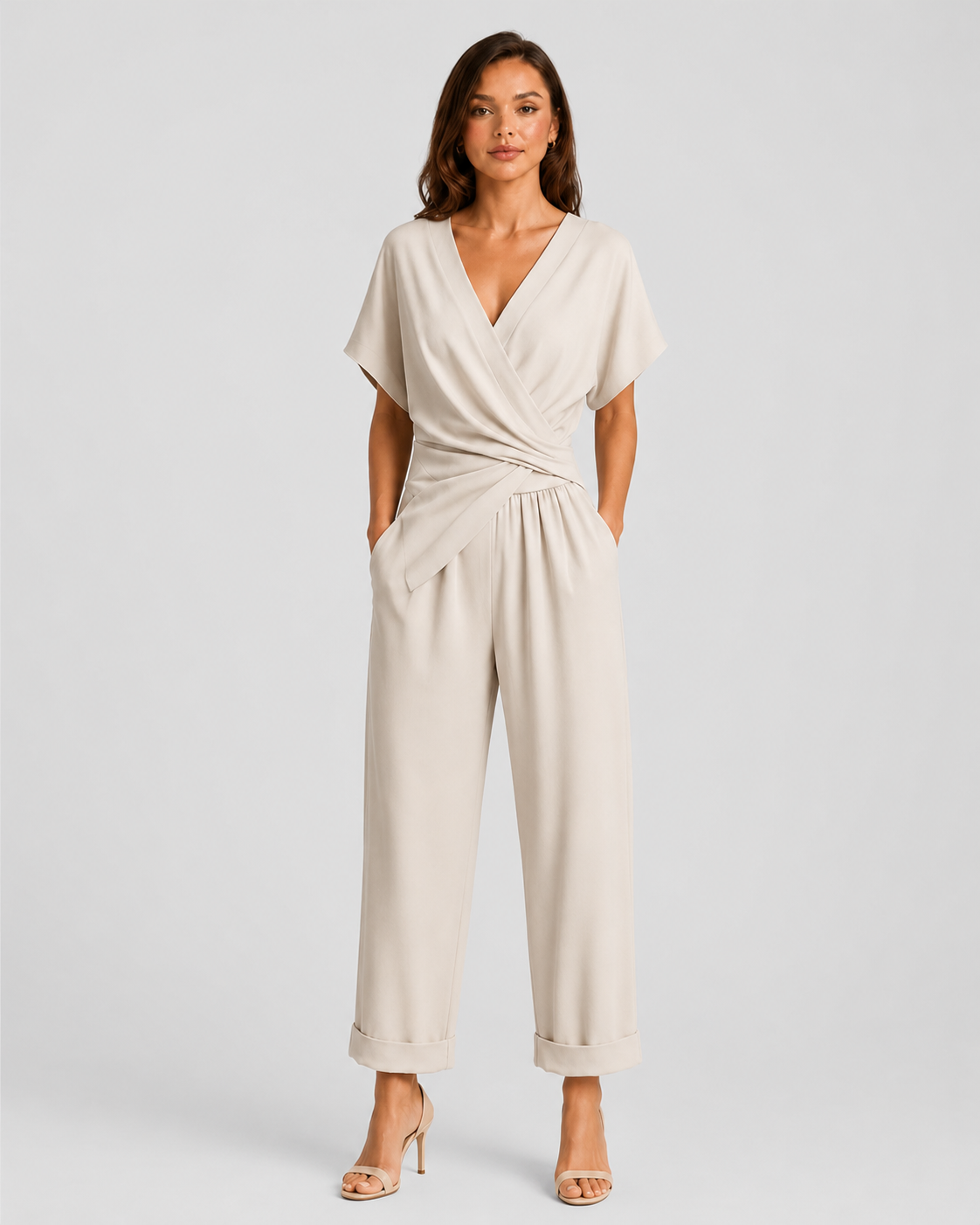 Woman wearing a lightweight wrap front co-ord set with relaxed cropped wide-leg trousers, styled for elegant summer occasions and holiday wear.
