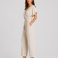 Woman wearing a lightweight wrap front co-ord set with relaxed cropped wide-leg trousers, styled for elegant summer occasions and holiday wear.