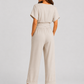 Woman wearing a lightweight wrap front co-ord set with relaxed cropped wide-leg trousers, styled for elegant summer occasions and holiday wear.