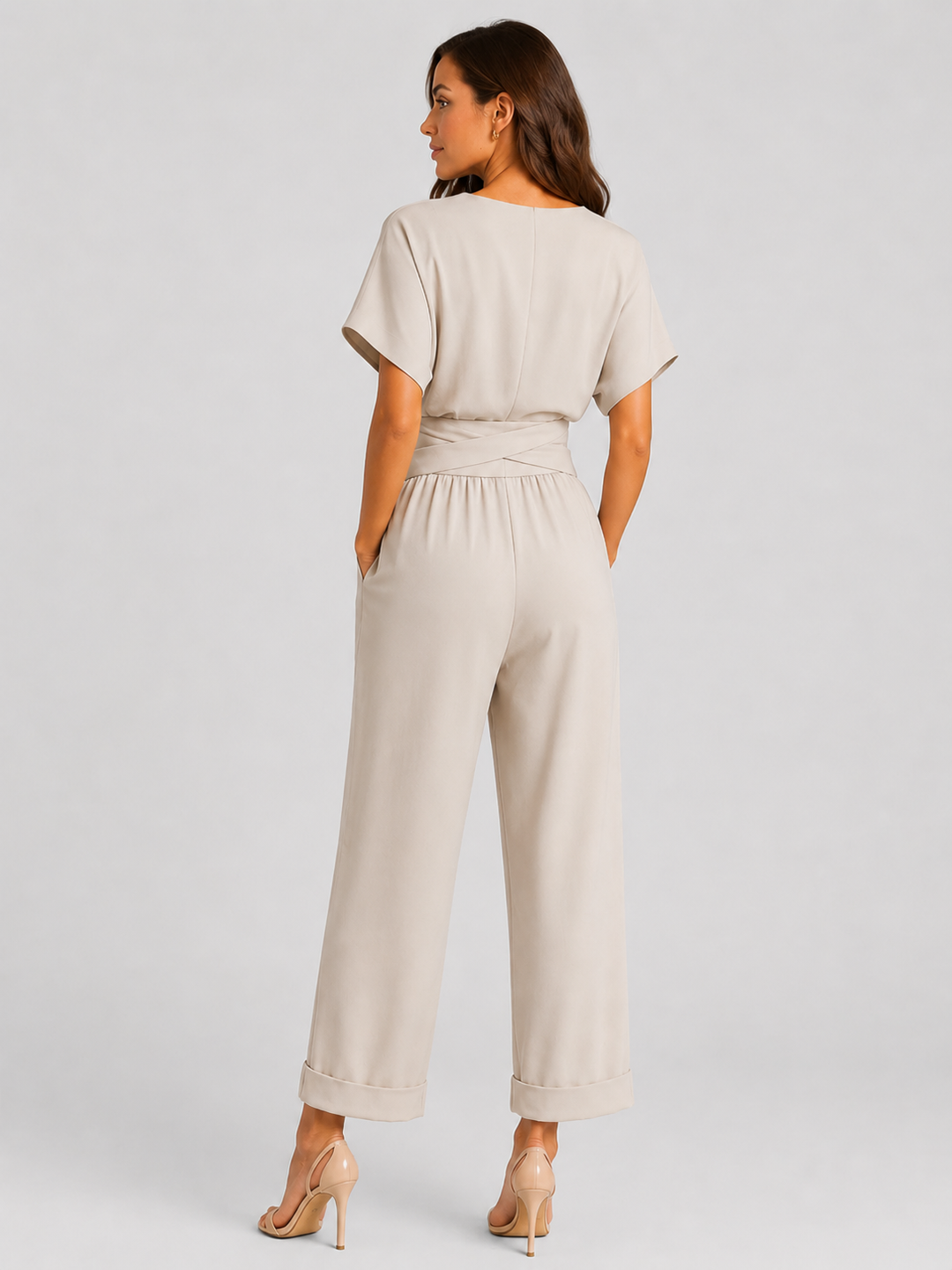 Woman wearing a lightweight wrap front co-ord set with relaxed cropped wide-leg trousers, styled for elegant summer occasions and holiday wear.