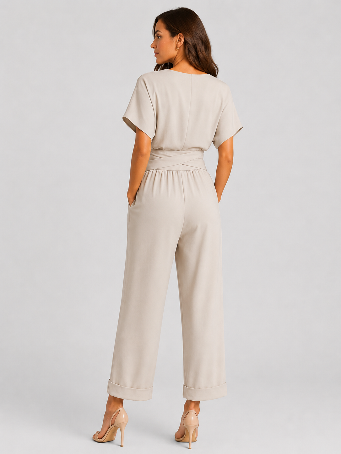 Woman wearing a lightweight wrap front co-ord set with relaxed cropped wide-leg trousers, styled for elegant summer occasions and holiday wear.