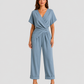 Woman wearing a lightweight wrap front co-ord set with relaxed cropped wide-leg trousers, styled for elegant summer occasions and holiday wear.