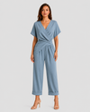 Woman wearing a lightweight wrap front co-ord set with relaxed cropped wide-leg trousers, styled for elegant summer occasions and holiday wear.