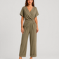 Woman wearing a lightweight wrap front co-ord set with relaxed cropped wide-leg trousers, styled for elegant summer occasions and holiday wear.