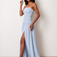 Woman wearing the Zofia strapless A-line maxi dress featuring a smocked square-neck bodice, shirred waist, flowing A-line skirt with a side slit, and a backless design.