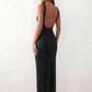 Woman wearing the Mihaela sequined low back maxi dress featuring allover sequin mesh, a square neckline, wide shoulder straps, a low open back, and a fitted floor-length sheath silhouette.