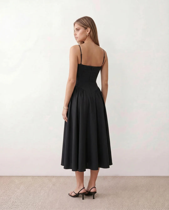 Women's sweetheart corset midi dress featuring a structured corset-inspired bodice, adjustable spaghetti straps, a defined waist, and a softly pleated A-line skirt. An elegant midi dress for weddings, cocktail parties, race days, and formal occasions.
