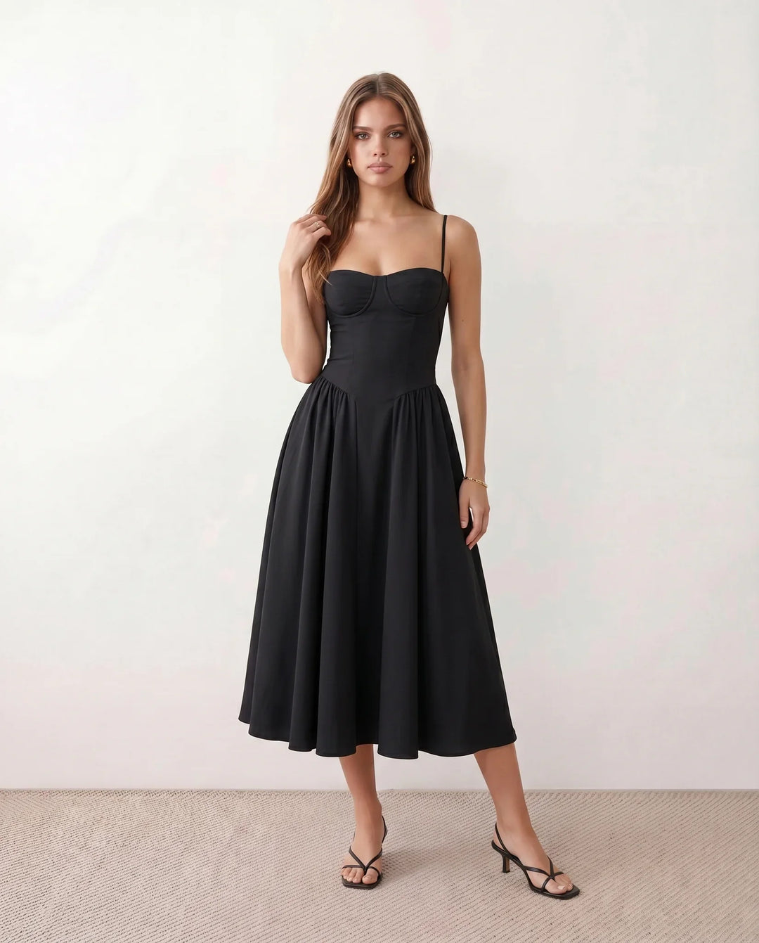 Women's sweetheart corset midi dress featuring a structured corset-inspired bodice, adjustable spaghetti straps, a defined waist, and a softly pleated A-line skirt. An elegant midi dress for weddings, cocktail parties, race days, and formal occasions.