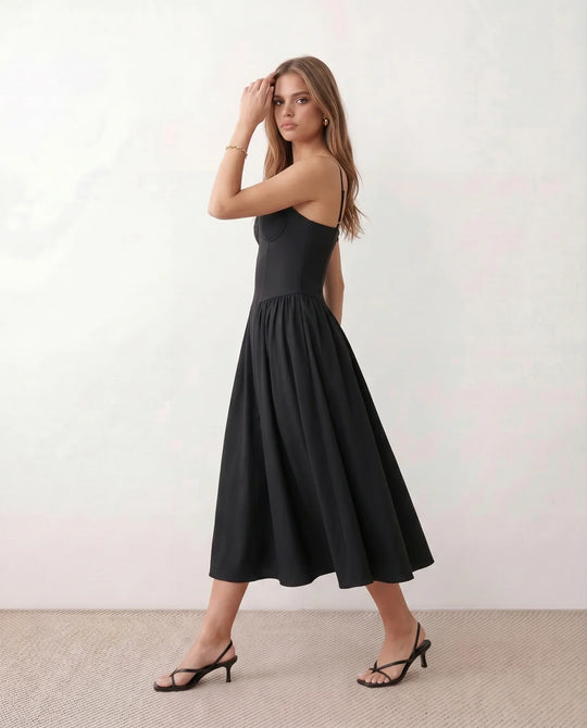 Women's sweetheart corset midi dress featuring a structured corset-inspired bodice, adjustable spaghetti straps, a defined waist, and a softly pleated A-line skirt. An elegant midi dress for weddings, cocktail parties, race days, and formal occasions.