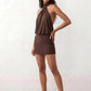 Woman wearing the Mae silk halter mini dress featuring a draped halter neckline, open back with adjustable tie-neck fastening, fitted bodycon mini silhouette, and smooth silk-look fabric, ideal for weddings, cocktail parties, and evening occasions.