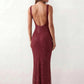 Woman wearing the Mihaela sequined low back maxi dress featuring allover sequin mesh, a square neckline, wide shoulder straps, a low open back, and a fitted floor-length sheath silhouette.