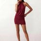 Woman wearing the Mae silk halter mini dress featuring a draped halter neckline, open back with adjustable tie-neck fastening, fitted bodycon mini silhouette, and smooth silk-look fabric, ideal for weddings, cocktail parties, and evening occasions.