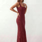 Woman wearing the Mihaela sequined low back maxi dress featuring allover sequin mesh, a square neckline, wide shoulder straps, a low open back, and a fitted floor-length sheath silhouette.
