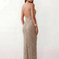 Woman wearing the Mihaela sequined low back maxi dress featuring allover sequin mesh, a square neckline, wide shoulder straps, a low open back, and a fitted floor-length sheath silhouette.