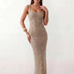 Woman wearing the Mihaela sequined low back maxi dress featuring allover sequin mesh, a square neckline, wide shoulder straps, a low open back, and a fitted floor-length sheath silhouette.