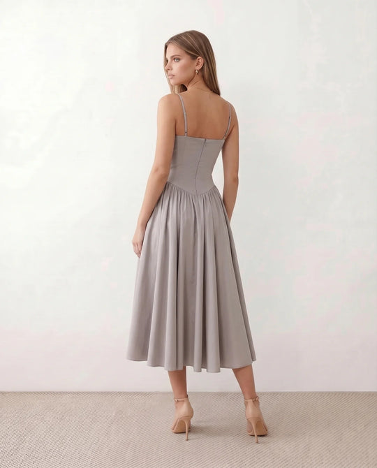 Women's sweetheart corset midi dress featuring a structured corset-inspired bodice, adjustable spaghetti straps, a defined waist, and a softly pleated A-line skirt. An elegant midi dress for weddings, cocktail parties, race days, and formal occasions.