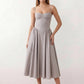 Women's sweetheart corset midi dress featuring a structured corset-inspired bodice, adjustable spaghetti straps, a defined waist, and a softly pleated A-line skirt. An elegant midi dress for weddings, cocktail parties, race days, and formal occasions.