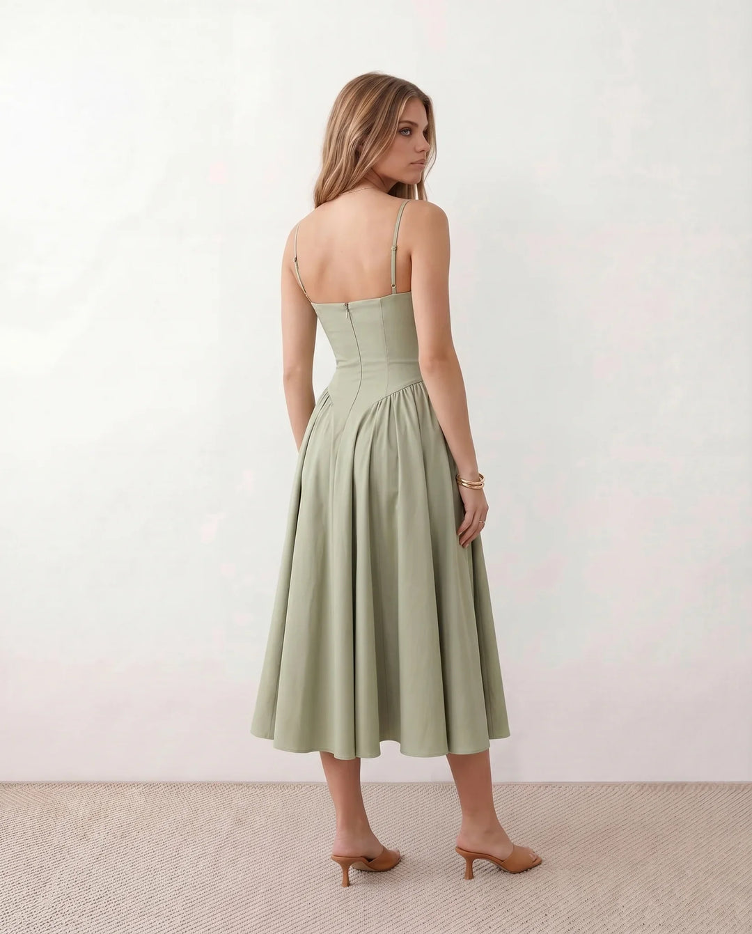 Women's sweetheart corset midi dress featuring a structured corset-inspired bodice, adjustable spaghetti straps, a defined waist, and a softly pleated A-line skirt. An elegant midi dress for weddings, cocktail parties, race days, and formal occasions.
