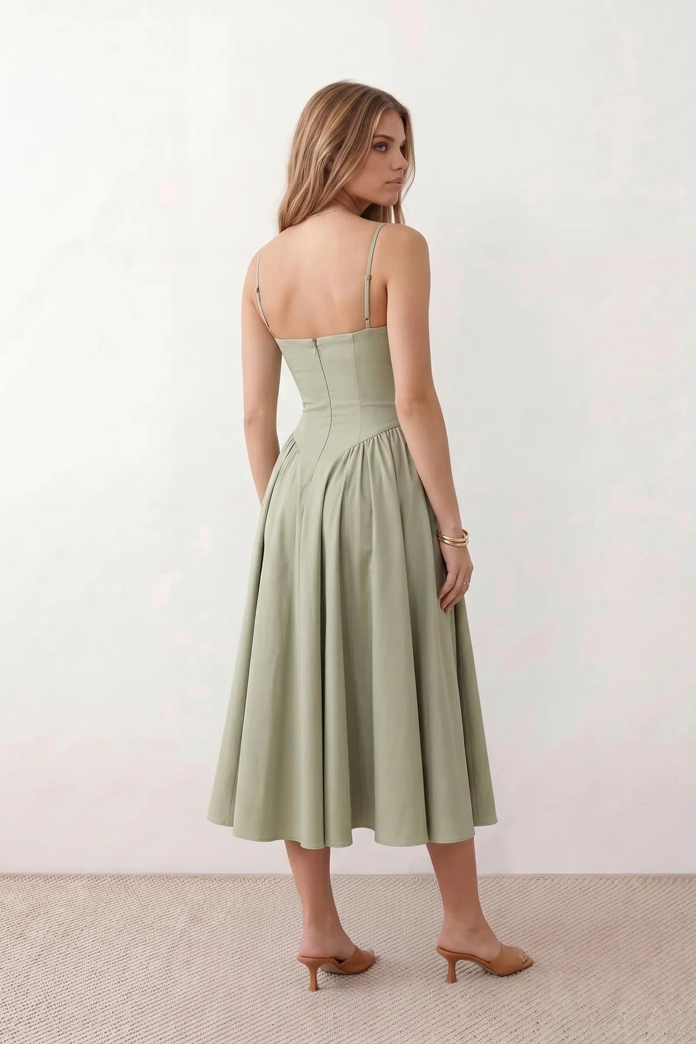 Women's sweetheart corset midi dress featuring a structured corset-inspired bodice, adjustable spaghetti straps, a defined waist, and a softly pleated A-line skirt. An elegant midi dress for weddings, cocktail parties, race days, and formal occasions.