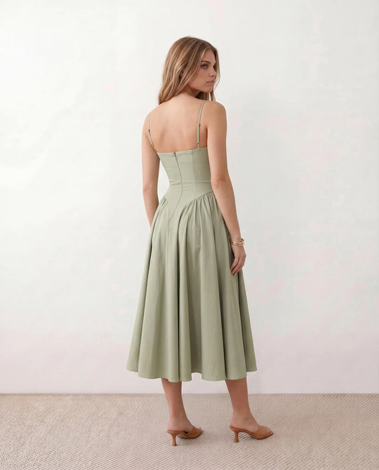 Women's sweetheart corset midi dress featuring a structured corset-inspired bodice, adjustable spaghetti straps, a defined waist, and a softly pleated A-line skirt. An elegant midi dress for weddings, cocktail parties, race days, and formal occasions.