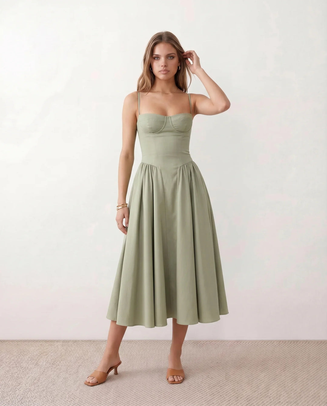 Women's sweetheart corset midi dress featuring a structured corset-inspired bodice, adjustable spaghetti straps, a defined waist, and a softly pleated A-line skirt. An elegant midi dress for weddings, cocktail parties, race days, and formal occasions.