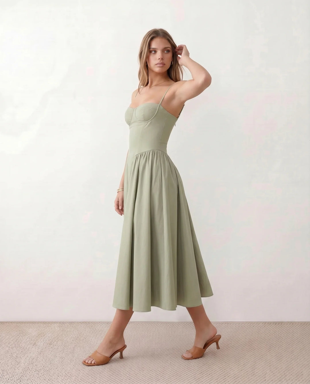 Women's sweetheart corset midi dress featuring a structured corset-inspired bodice, adjustable spaghetti straps, a defined waist, and a softly pleated A-line skirt. An elegant midi dress for weddings, cocktail parties, race days, and formal occasions.