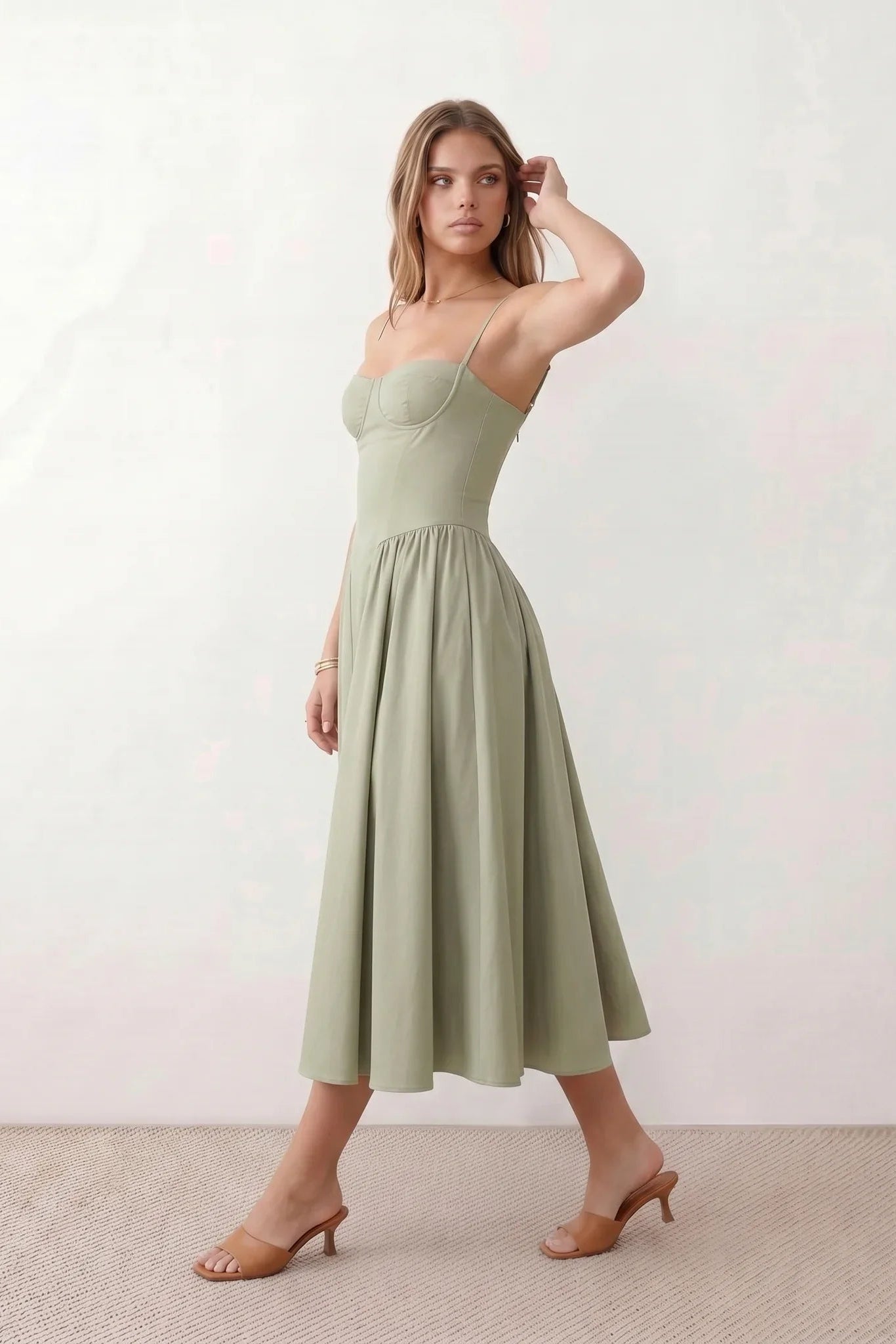 Women's sweetheart corset midi dress featuring a structured corset-inspired bodice, adjustable spaghetti straps, a defined waist, and a softly pleated A-line skirt. An elegant midi dress for weddings, cocktail parties, race days, and formal occasions.