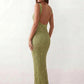 Woman wearing the Mihaela sequined low back maxi dress featuring allover sequin mesh, a square neckline, wide shoulder straps, a low open back, and a fitted floor-length sheath silhouette.