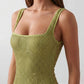 Woman wearing the Mihaela sequined low back maxi dress featuring allover sequin mesh, a square neckline, wide shoulder straps, a low open back, and a fitted floor-length sheath silhouette.