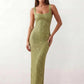 Woman wearing the Mihaela sequined low back maxi dress featuring allover sequin mesh, a square neckline, wide shoulder straps, a low open back, and a fitted floor-length sheath silhouette.