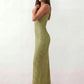 Woman wearing the Mihaela sequined low back maxi dress featuring allover sequin mesh, a square neckline, wide shoulder straps, a low open back, and a fitted floor-length sheath silhouette.
