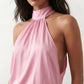Woman wearing the Mae silk halter mini dress featuring a draped halter neckline, open back with adjustable tie-neck fastening, fitted bodycon mini silhouette, and smooth silk-look fabric, ideal for weddings, cocktail parties, and evening occasions.