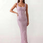Woman wearing the Mihaela sequined low back maxi dress featuring allover sequin mesh, a square neckline, wide shoulder straps, a low open back, and a fitted floor-length sheath silhouette.