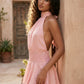 Bella Glossy Halter Mini Dress with a halter mock neckline, tie-back closure, smocked waist, open back, and tiered ruffle mini skirt in a glossy finish, available in Beige, Red, Purple, Yellow, Pink, and Light Blue.
