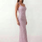 Woman wearing the Mihaela sequined low back maxi dress featuring allover sequin mesh, a square neckline, wide shoulder straps, a low open back, and a fitted floor-length sheath silhouette.