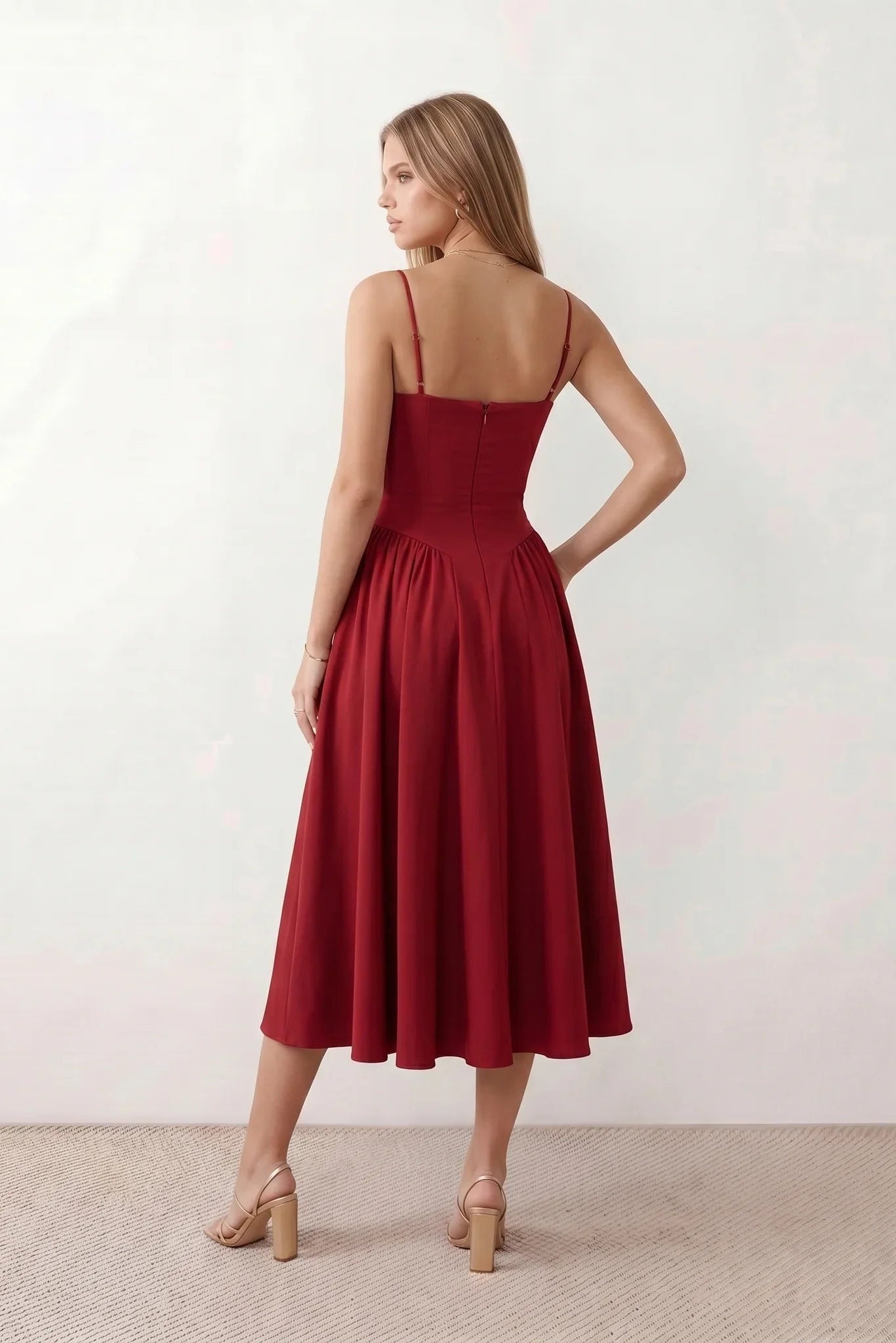 Women's sweetheart corset midi dress featuring a structured corset-inspired bodice, adjustable spaghetti straps, a defined waist, and a softly pleated A-line skirt. An elegant midi dress for weddings, cocktail parties, race days, and formal occasions.