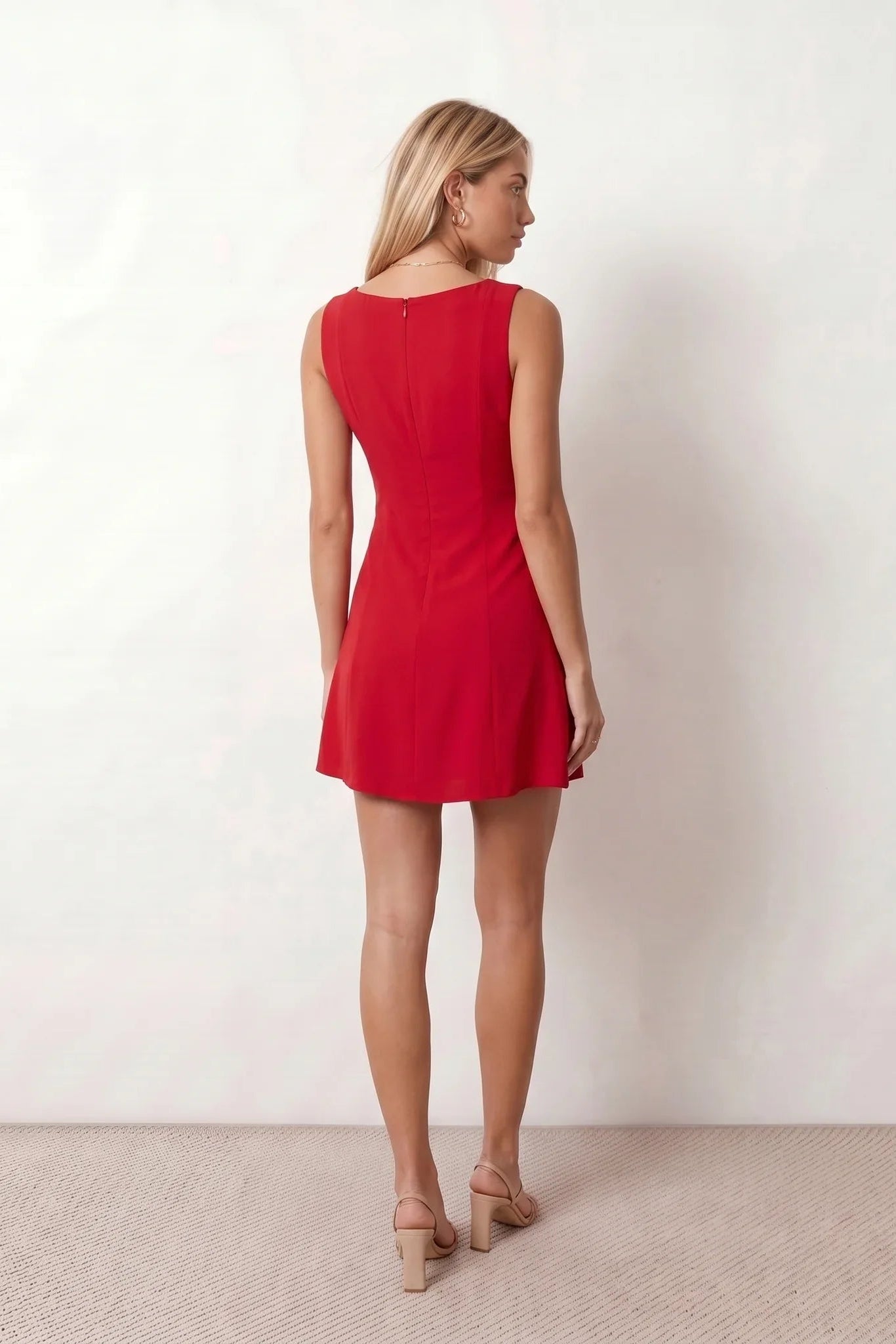 Maraea fitted sleeveless mini dress with a boat neckline, structured sheath silhouette, smooth finish, straight mini hem, and center back zip closure.