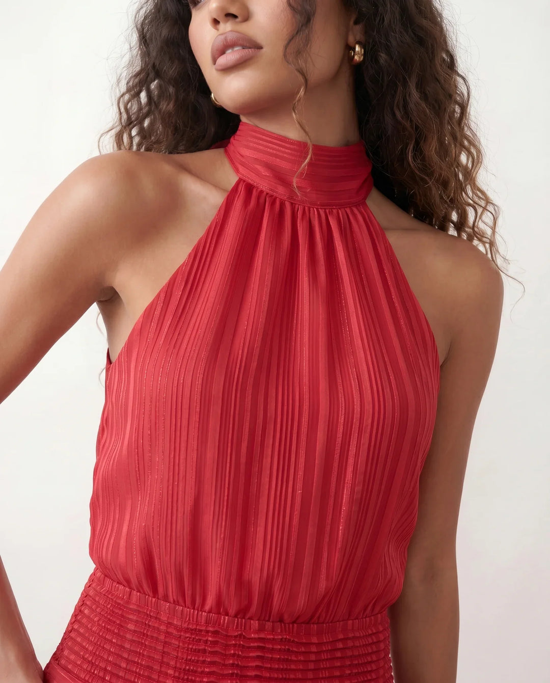 Bella Glossy Halter Mini Dress with a halter mock neckline, tie-back closure, smocked waist, open back, and tiered ruffle mini skirt in a glossy finish, available in Beige, Red, Purple, Yellow, Pink, and Light Blue.