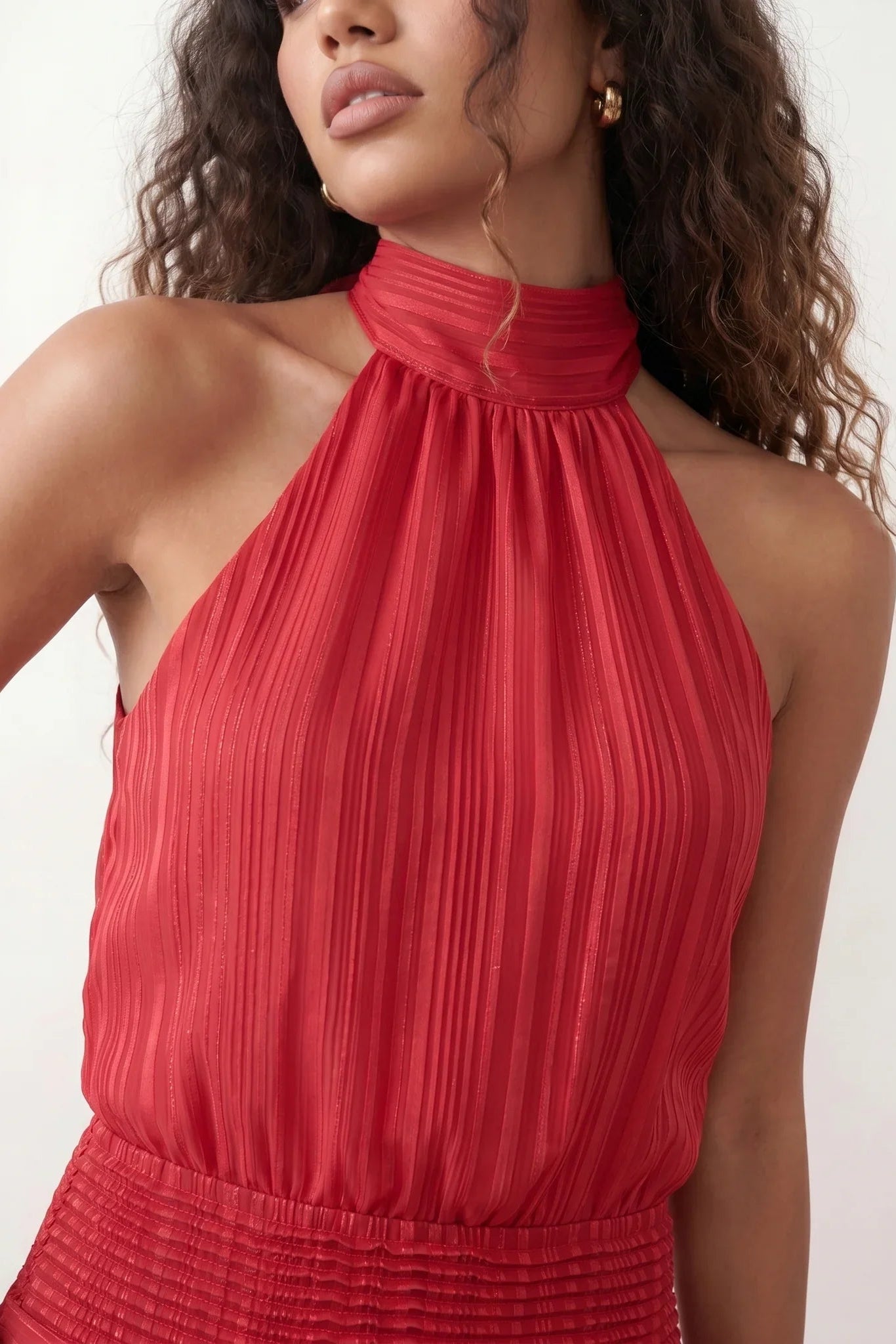 Bella Glossy Halter Mini Dress with a halter mock neckline, tie-back closure, smocked waist, open back, and tiered ruffle mini skirt in a glossy finish, available in Beige, Red, Purple, Yellow, Pink, and Light Blue.