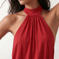 Woman wearing the Mae silk halter mini dress featuring a draped halter neckline, open back with adjustable tie-neck fastening, fitted bodycon mini silhouette, and smooth silk-look fabric, ideal for weddings, cocktail parties, and evening occasions.