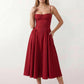 Women's sweetheart corset midi dress featuring a structured corset-inspired bodice, adjustable spaghetti straps, a defined waist, and a softly pleated A-line skirt. An elegant midi dress for weddings, cocktail parties, race days, and formal occasions.