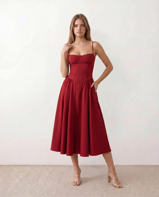 Women's sweetheart corset midi dress featuring a structured corset-inspired bodice, adjustable spaghetti straps, a defined waist, and a softly pleated A-line skirt. An elegant midi dress for weddings, cocktail parties, race days, and formal occasions.