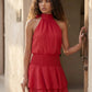 Bella Glossy Halter Mini Dress with a halter mock neckline, tie-back closure, smocked waist, open back, and tiered ruffle mini skirt in a glossy finish, available in Beige, Red, Purple, Yellow, Pink, and Light Blue.