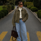 SculpStore women's faux suede oversized padded bomber jacket with zip-front varsity styling.