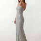 Woman wearing the Mihaela sequined low back maxi dress featuring allover sequin mesh, a square neckline, wide shoulder straps, a low open back, and a fitted floor-length sheath silhouette.