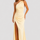 Woman wearing a soft beige asymmetric maxi dress with a one-shoulder neckline, fitted bodice, elegant draped silhouette and thigh-high side split, styled for weddings, evening events and formal occasions.