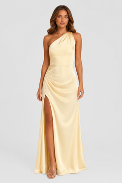 Woman wearing a soft beige asymmetric maxi dress with a one-shoulder neckline, fitted bodice, elegant draped silhouette and thigh-high side split, styled for weddings, evening events and formal occasions.
